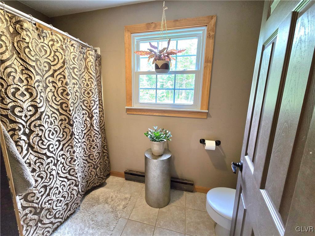 2231 Mountain Road Slatington, PA 18080 - Photo 20 of 41 a bathroom with a toilet and a shower curtain
