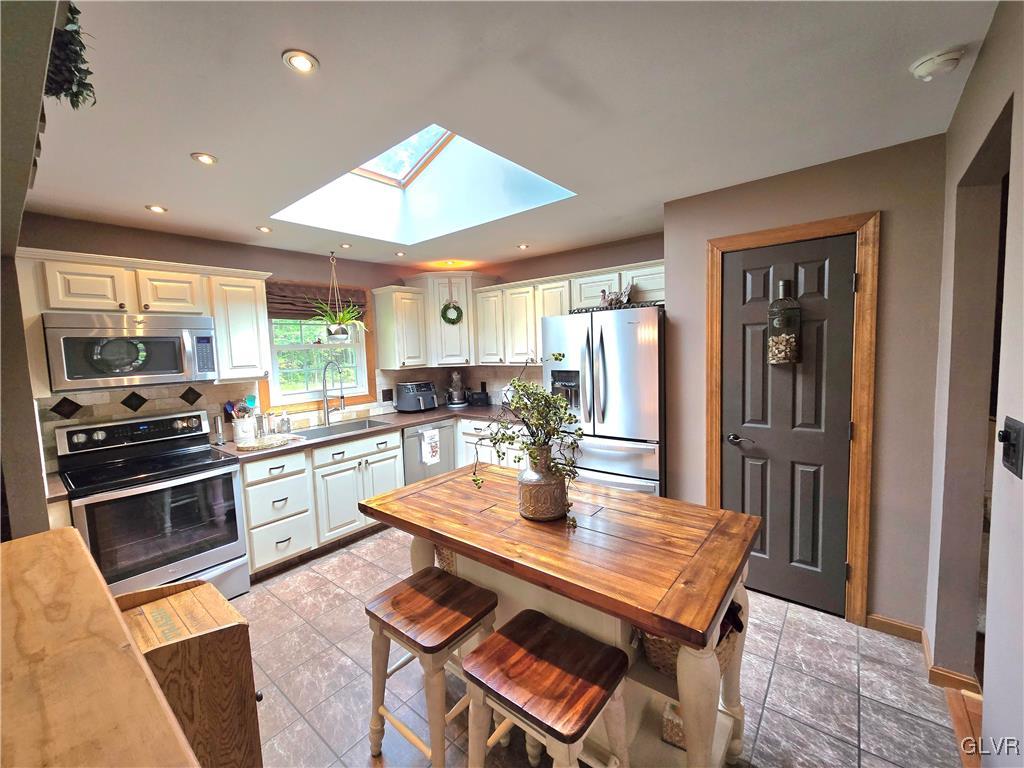2231 Mountain Road Slatington, PA 18080 - Photo 6 of 41 a kitchen with a stove a refrigerator and a dining table