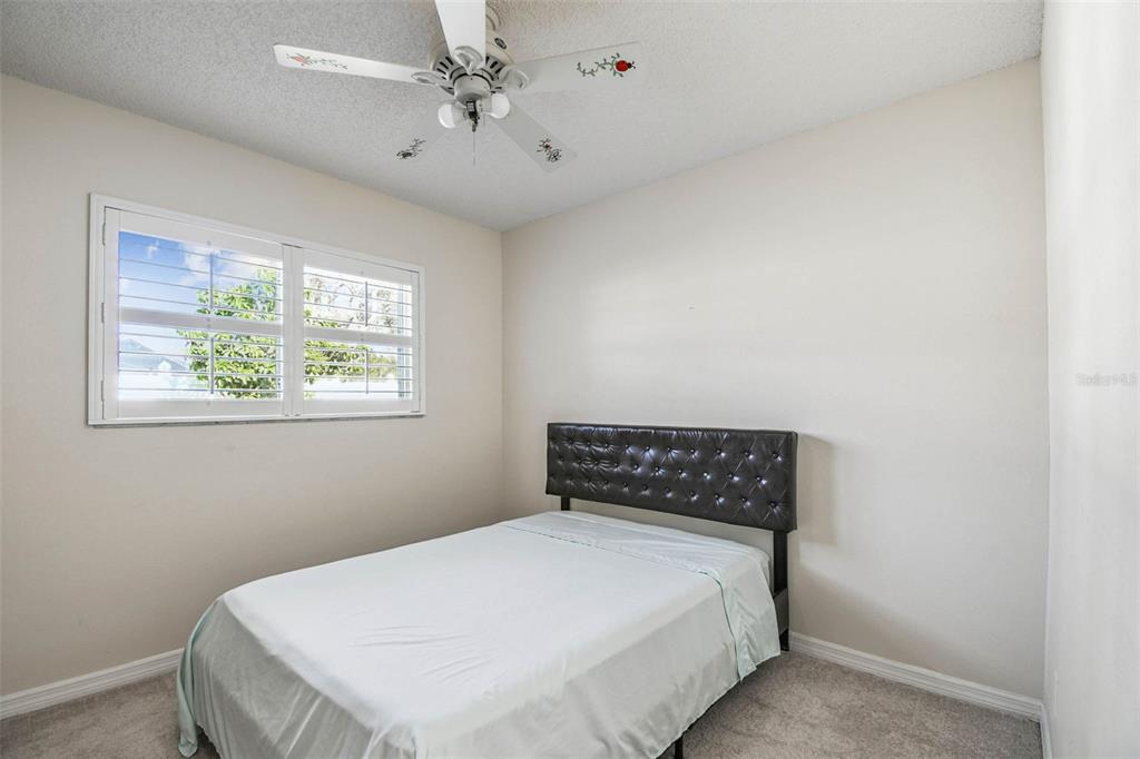 4161 Rolling Springs Drive Tampa, FL 33624 - Photo 16 of 52 a bedroom with a bed and a window