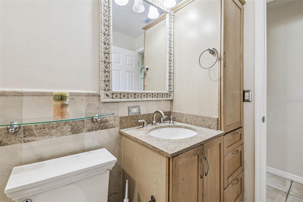 4161 Rolling Springs Drive Tampa, FL 33624 - Photo 19 of 52 a bathroom with a sink and a mirror