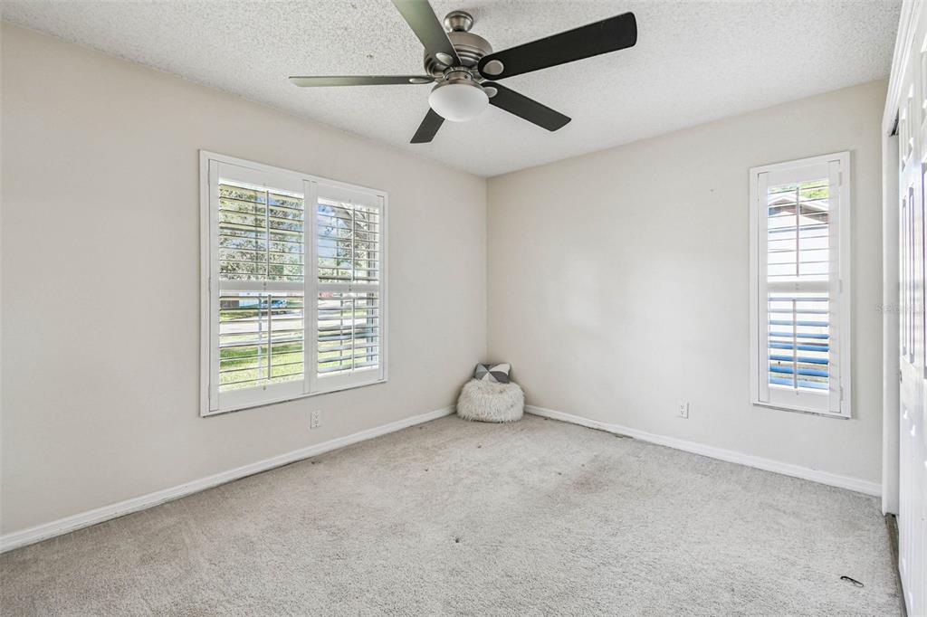 4161 Rolling Springs Drive Tampa, FL 33624 - Photo 20 of 52 an empty room with windows and fan