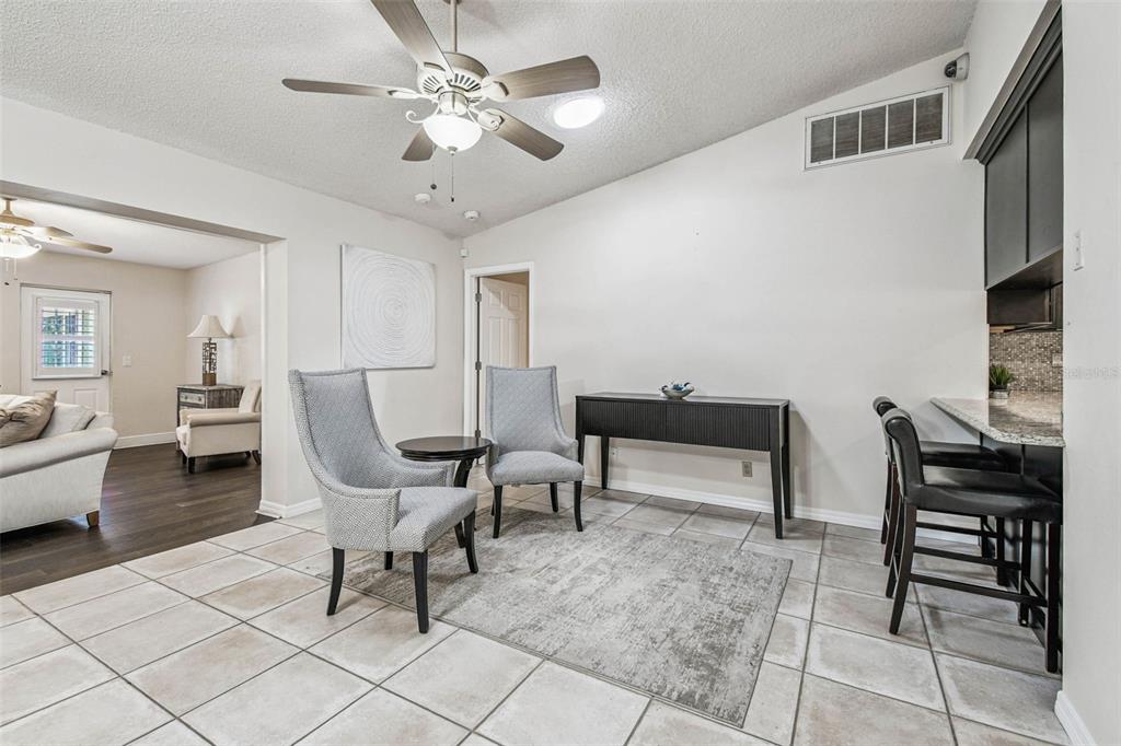 4161 Rolling Springs Drive Tampa, FL 33624 - Photo 23 of 52 a living room with furniture and a chandelier