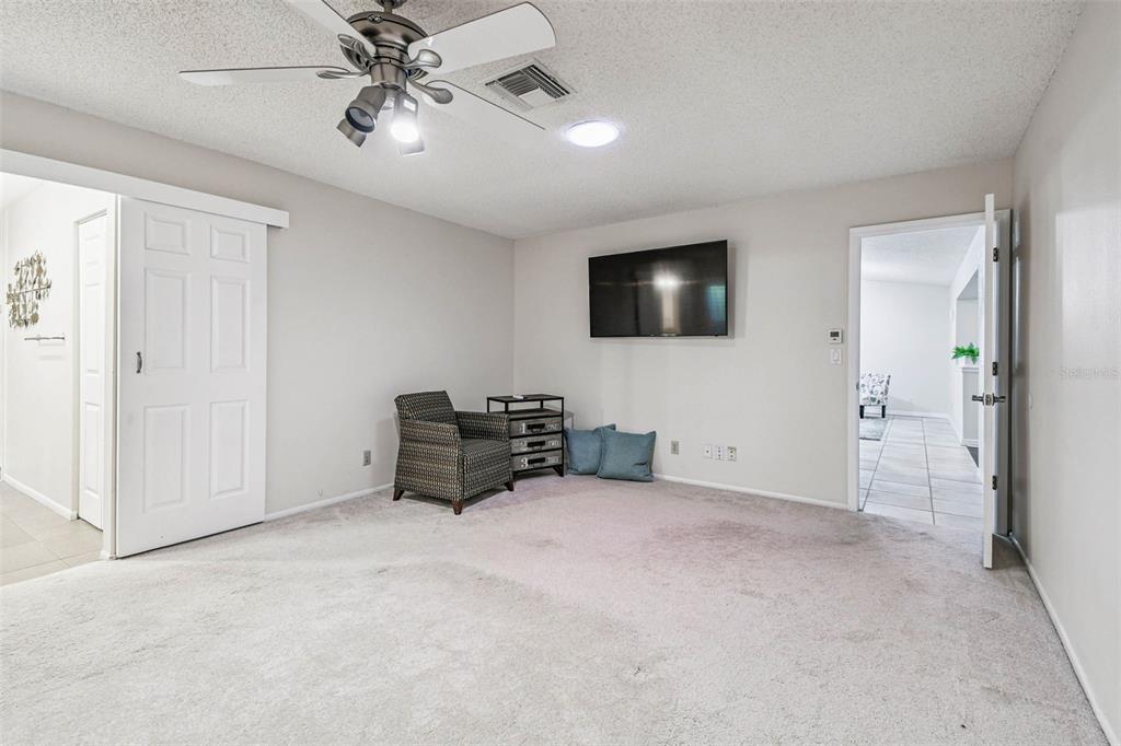4161 Rolling Springs Drive Tampa, FL 33624 - Photo 25 of 52 en empty room with furniture and a flat screen tv