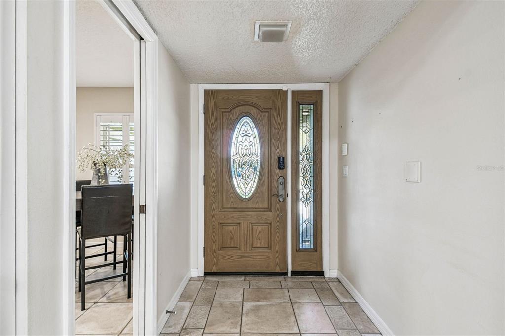 4161 Rolling Springs Drive Tampa, FL 33624 - Photo 5 of 52 a view of entryway with wooden floor