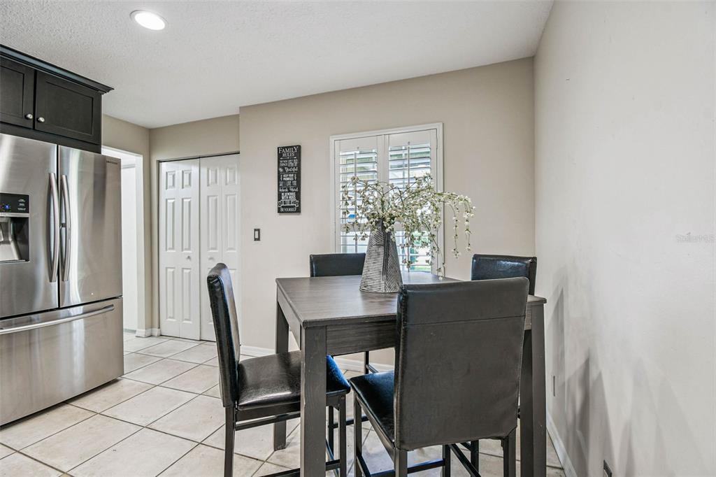 4161 Rolling Springs Drive Tampa, FL 33624 - Photo 9 of 52 a view of a dining room with furniture and a chandelier