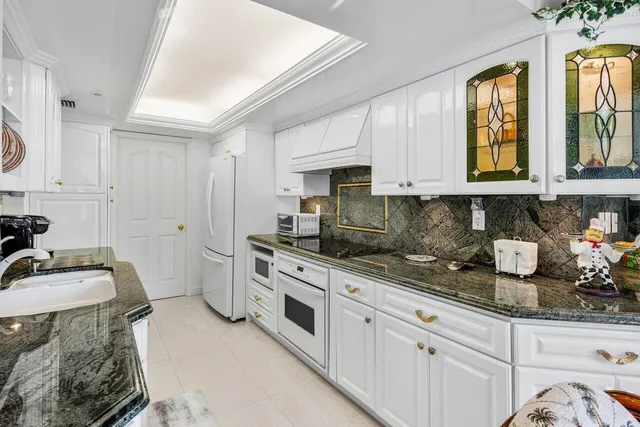 a kitchen with stainless steel appliances granite countertop a sink stove and cabinets