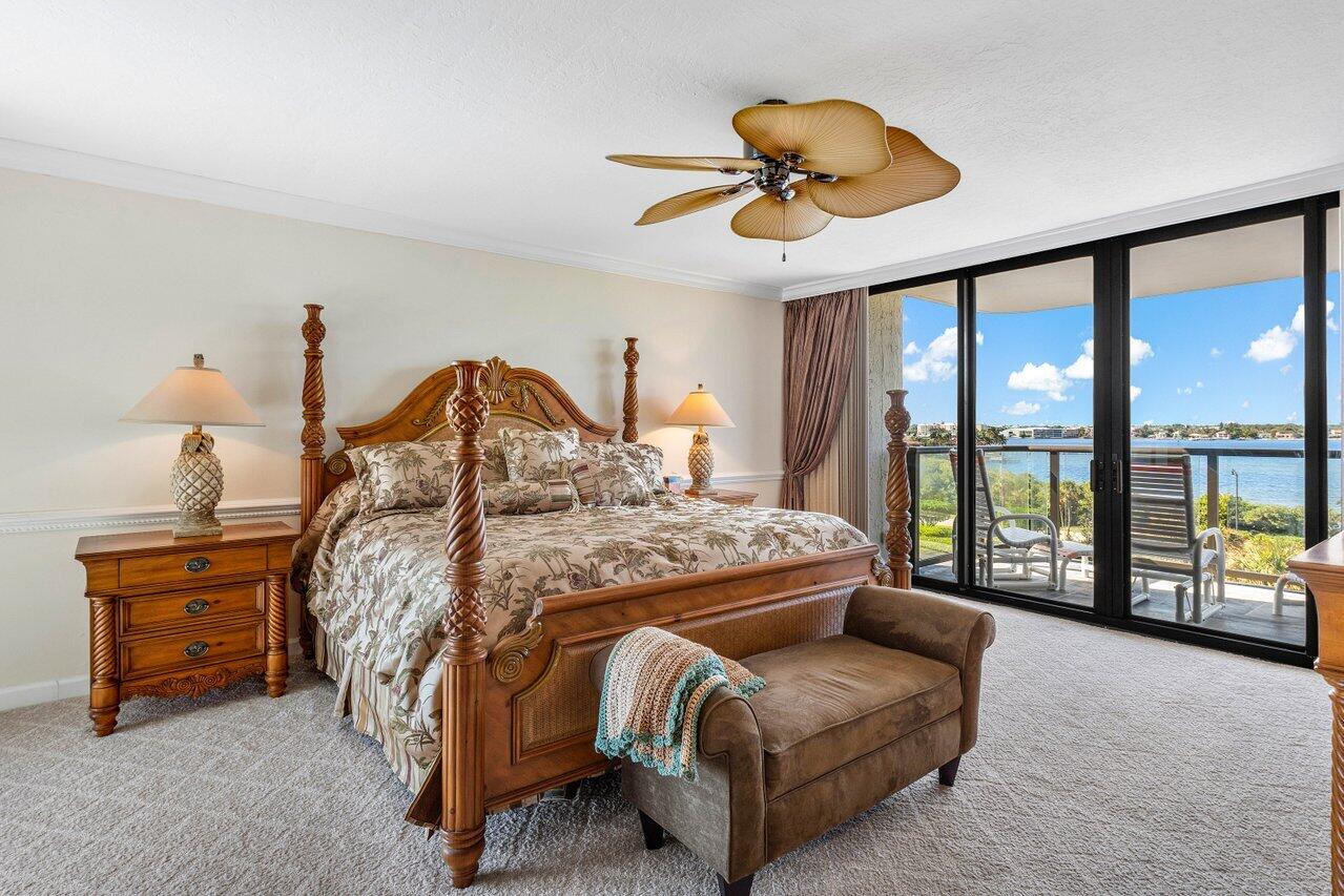 3440 South Ocean Boulevard, Unit 508N Palm Beach, FL 33480 - Photo 15 of 34 a bedroom with a bed and a large window