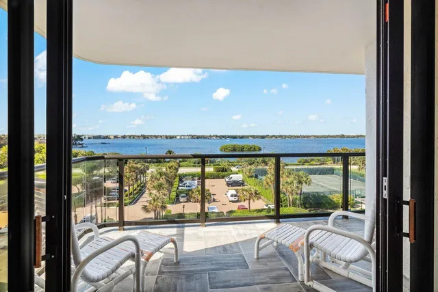 a view of a living room and floor to ceiling window and an outdoor view