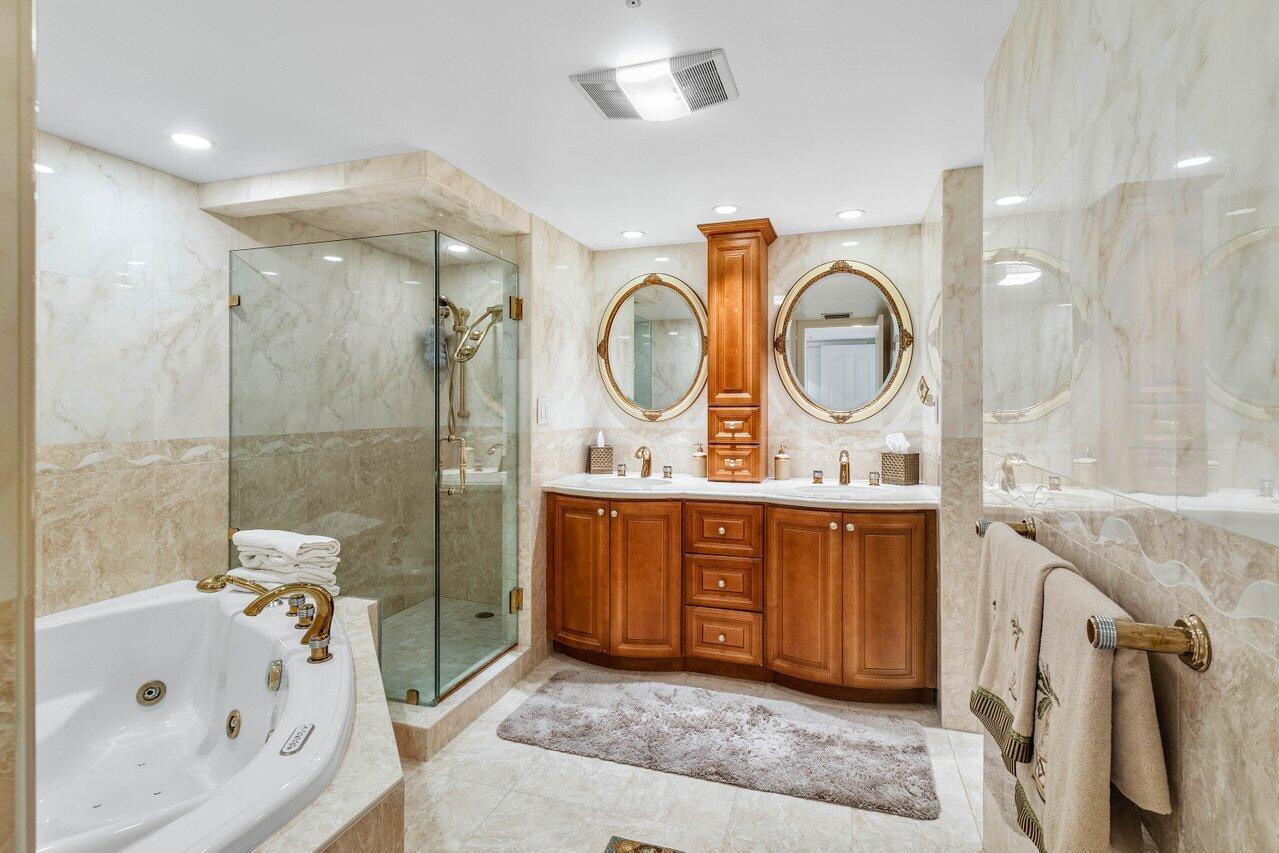 3440 South Ocean Boulevard, Unit 508N Palm Beach, FL 33480 - Photo 20 of 34 a bathroom with a tub sink and mirror