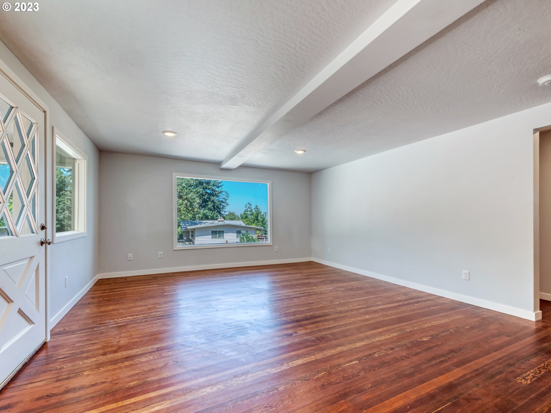 2285 City View Street Eugene, OR 97405 - Photo 11 of 47 a view of an empty room with window and wooden floor