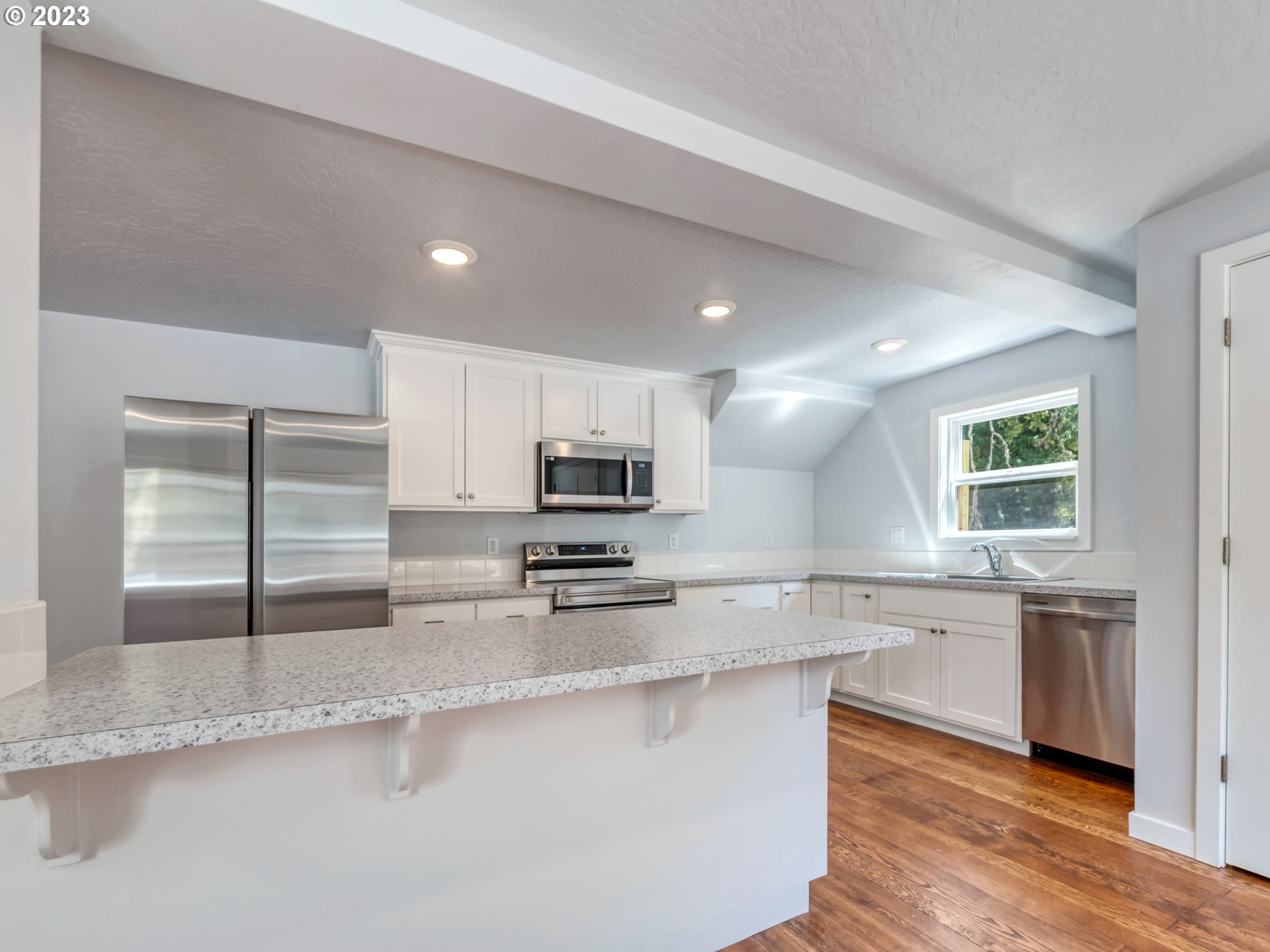 2285 City View Street Eugene, OR 97405 - Photo 15 of 47 a kitchen with stainless steel appliances a sink stove and cabinets