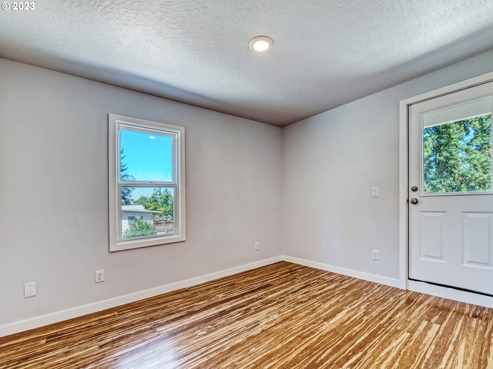 2285 City View Street Eugene, OR 97405 - Photo 19 of 47 an empty room with wooden floor and windows