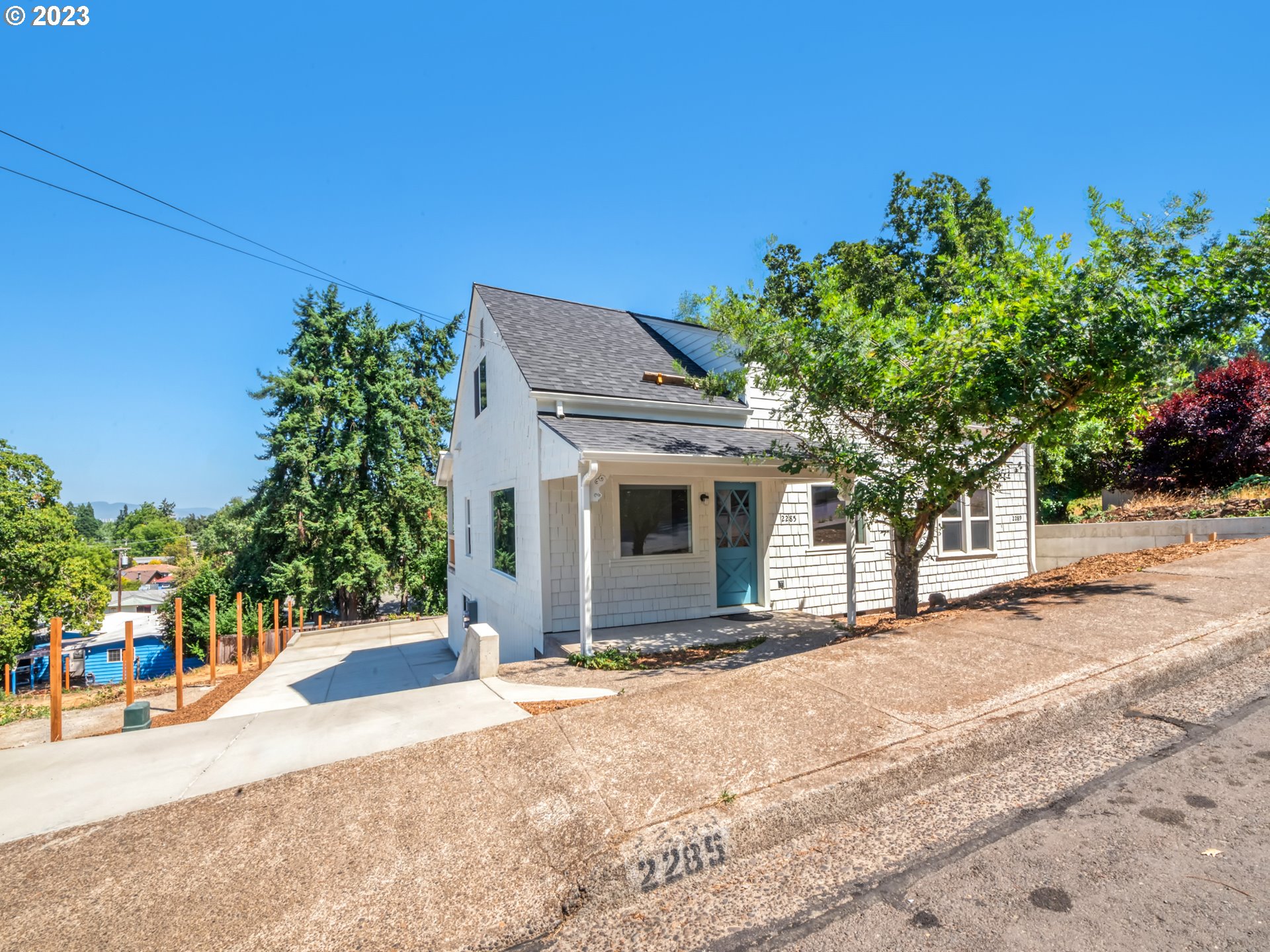 2285 City View Street Eugene, OR 97405 - Photo 2 of 47 a front view of a house with a yard and garage