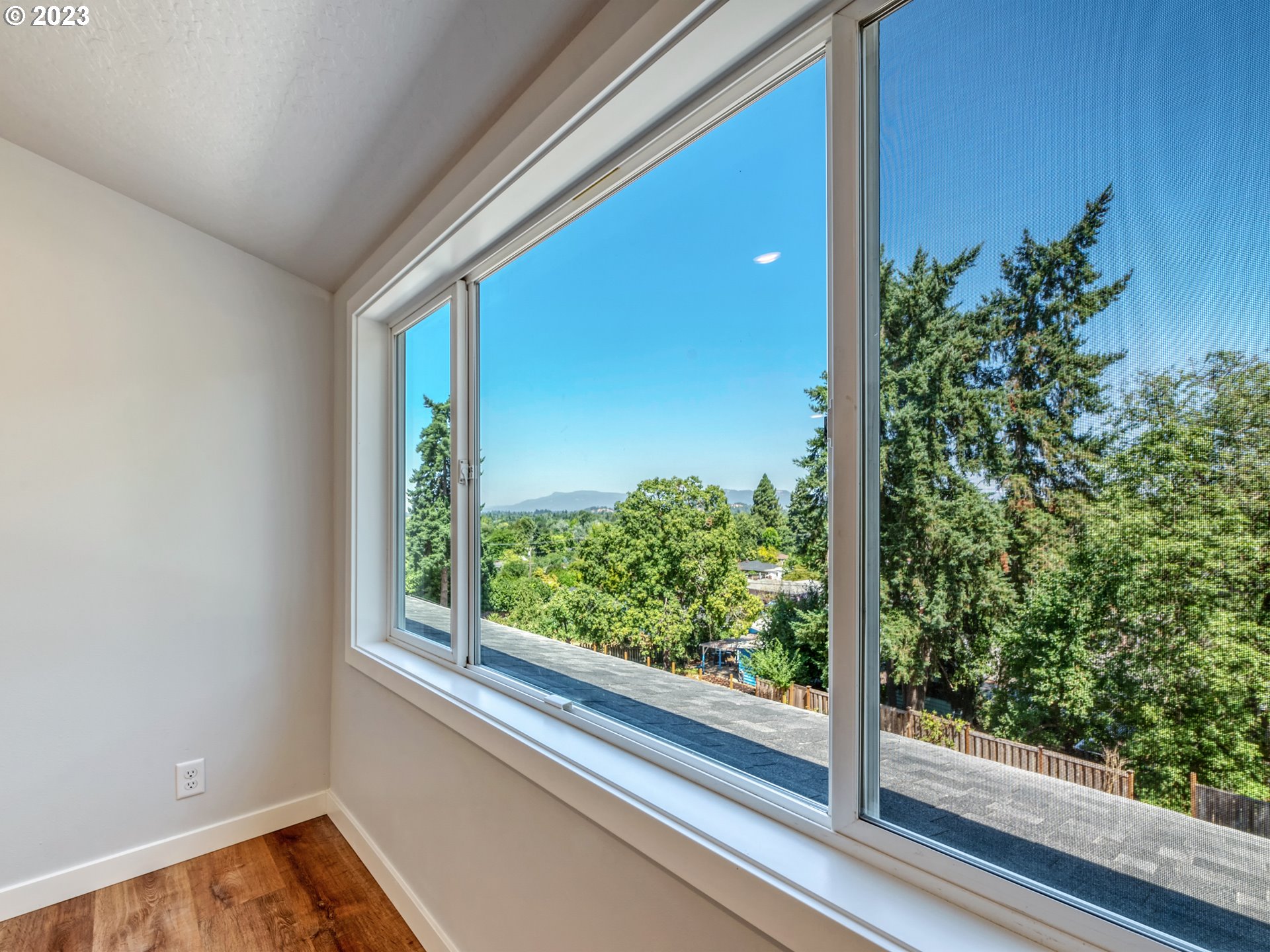 2285 City View Street Eugene, OR 97405 - Photo 25 of 47 a view of a room that has a large window and wooden floor