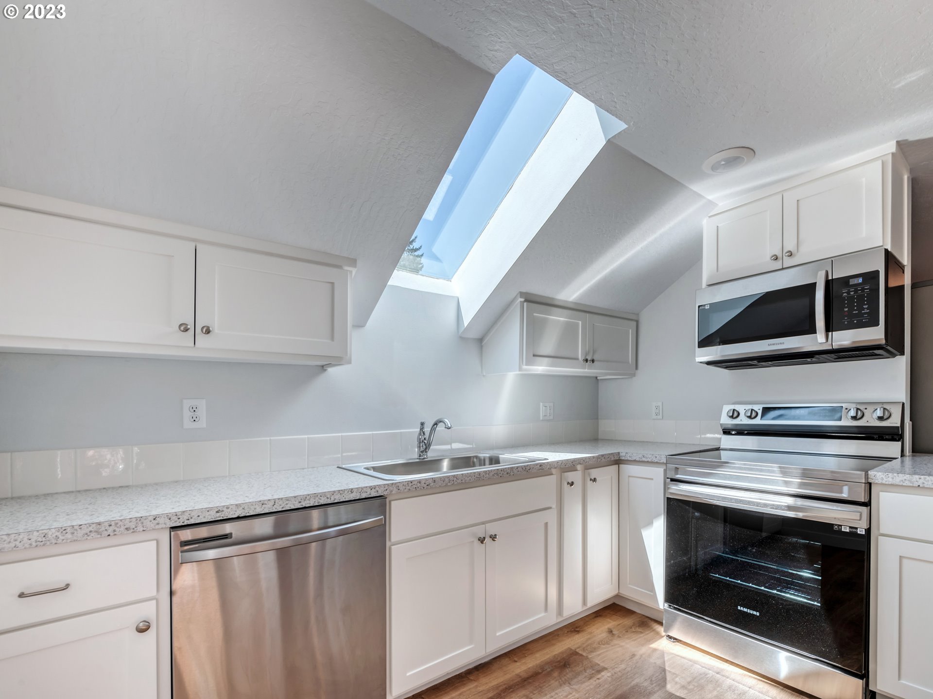 2285 City View Street Eugene, OR 97405 - Photo 29 of 47 a kitchen with granite countertop a stove sink and microwave