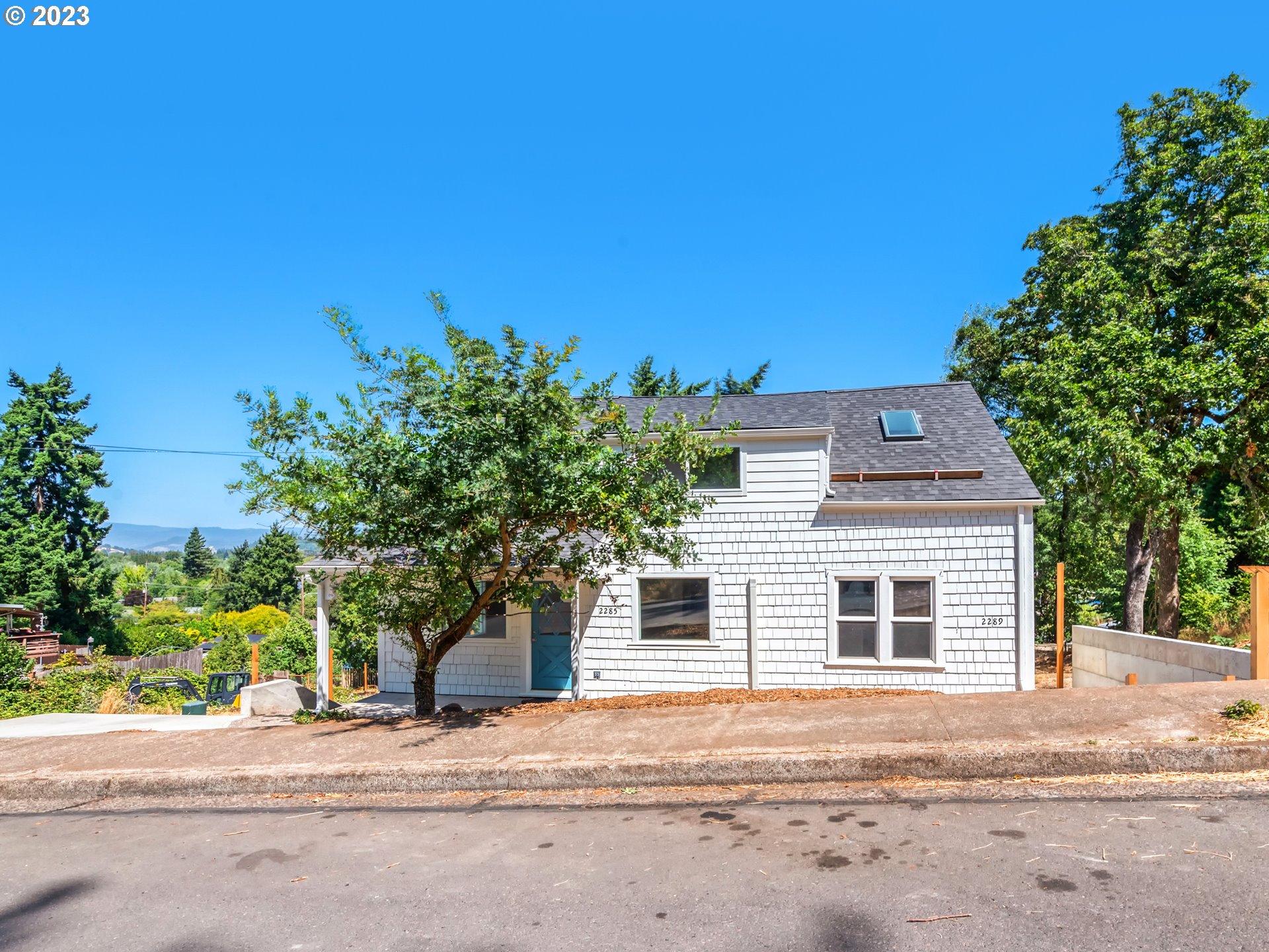 2285 City View Street Eugene, OR 97405 - Photo 3 of 47 a front view of a house with a yard and garage