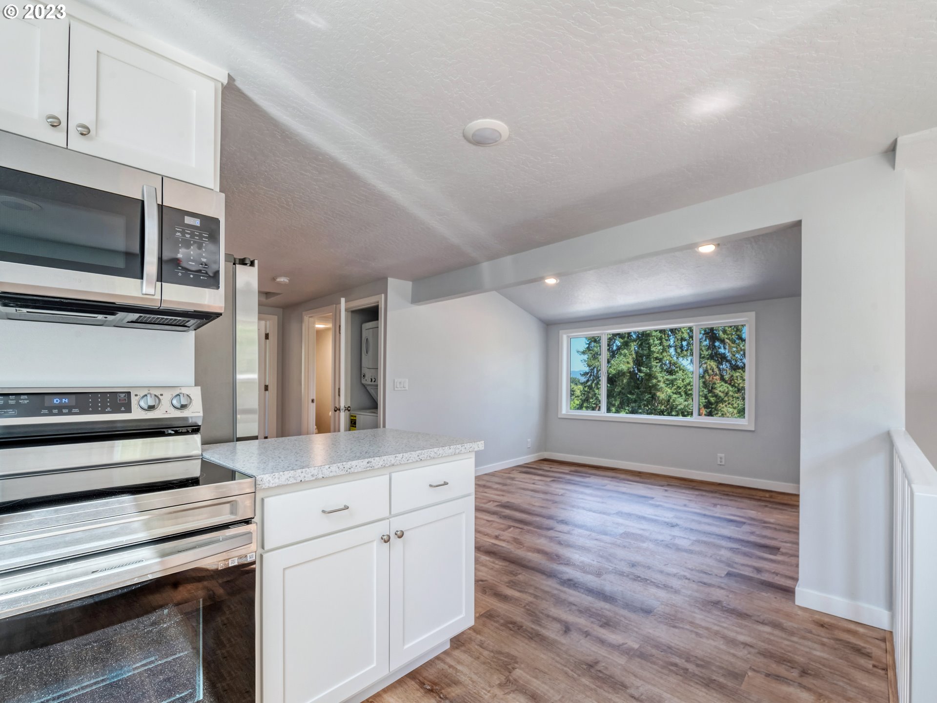 2285 City View Street Eugene, OR 97405 - Photo 32 of 47 a kitchen with stainless steel appliances granite countertop a stove a sink and a microwave