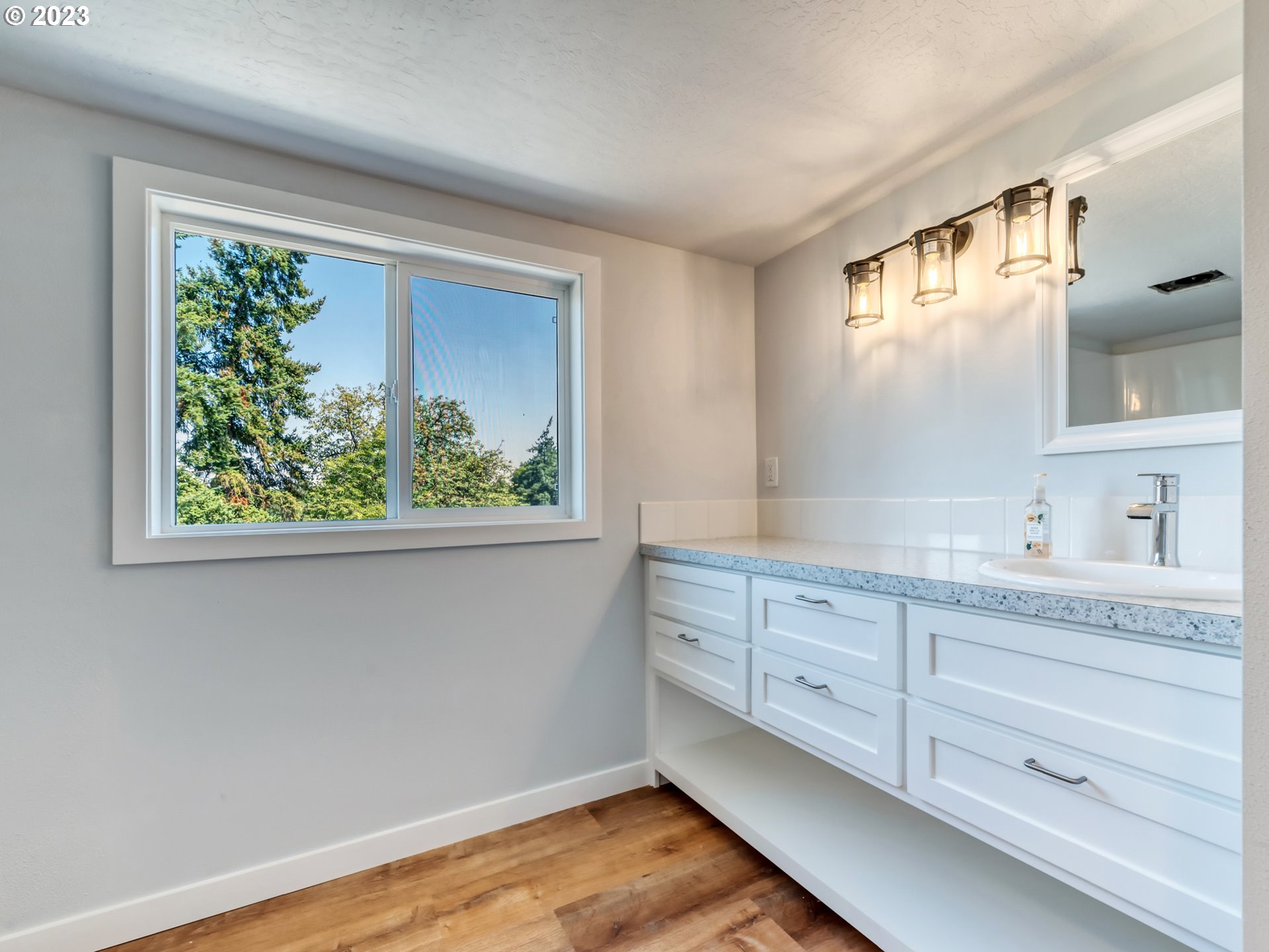 2285 City View Street Eugene, OR 97405 - Photo 39 of 47 a spacious bathroom with a granite countertop sink and a window