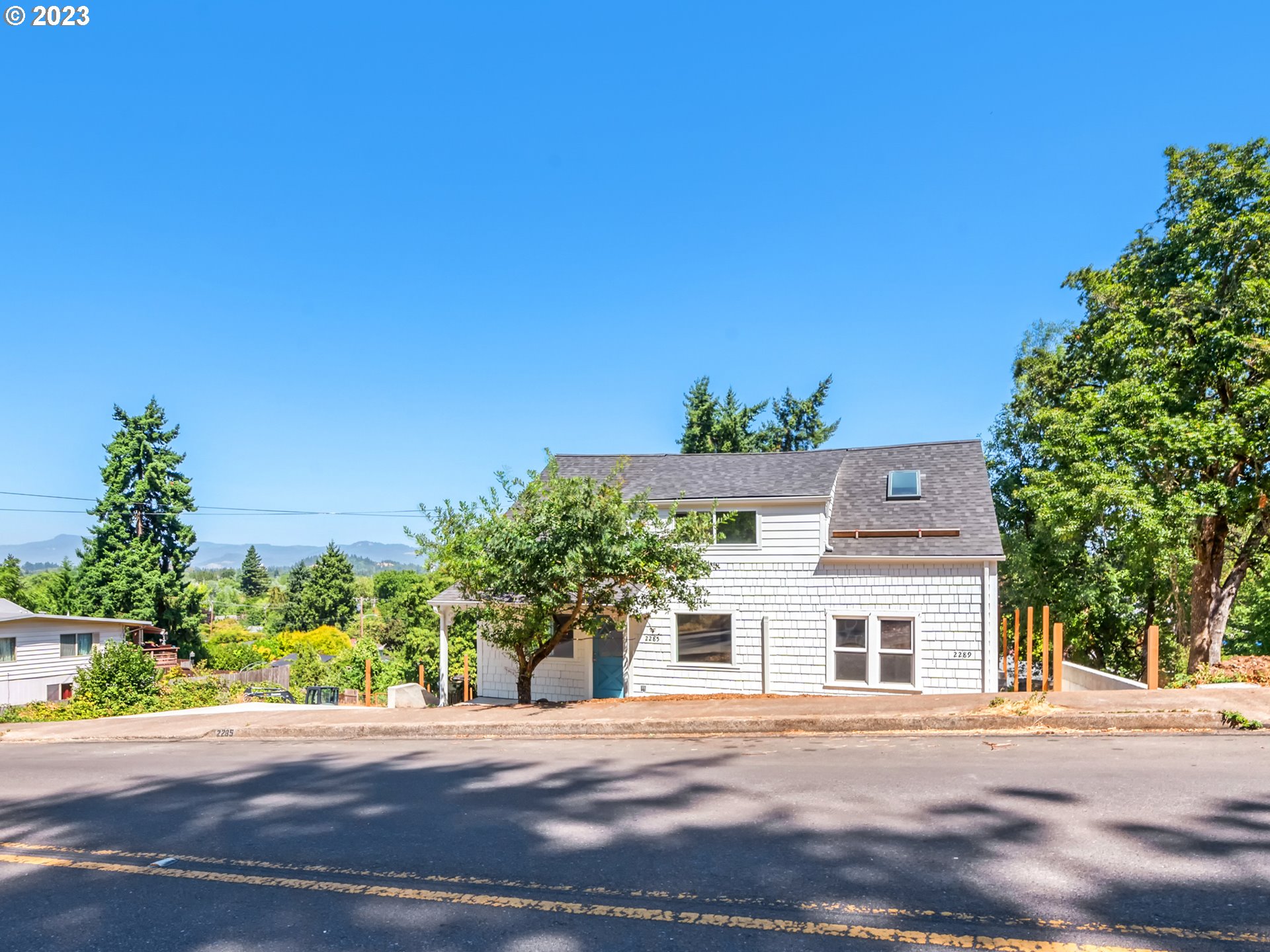 2285 City View Street Eugene, OR 97405 - Photo 4 of 47 a front view of a house with a yard and garage