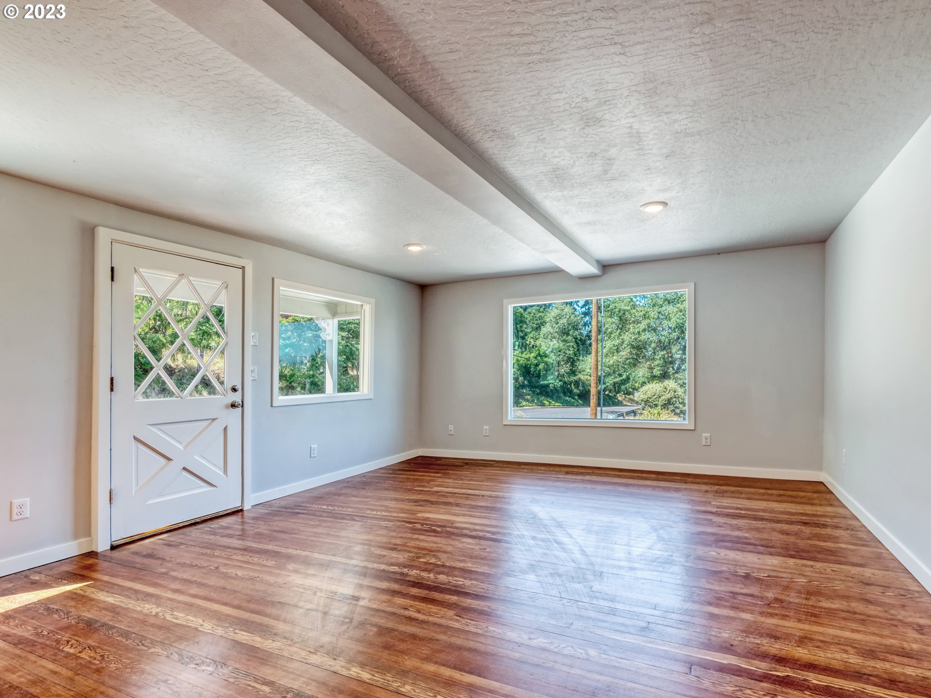 2285 City View Street Eugene, OR 97405 - Photo 9 of 47 an empty room with wooden floor and windows