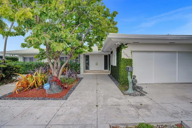a view of a house with potted plants