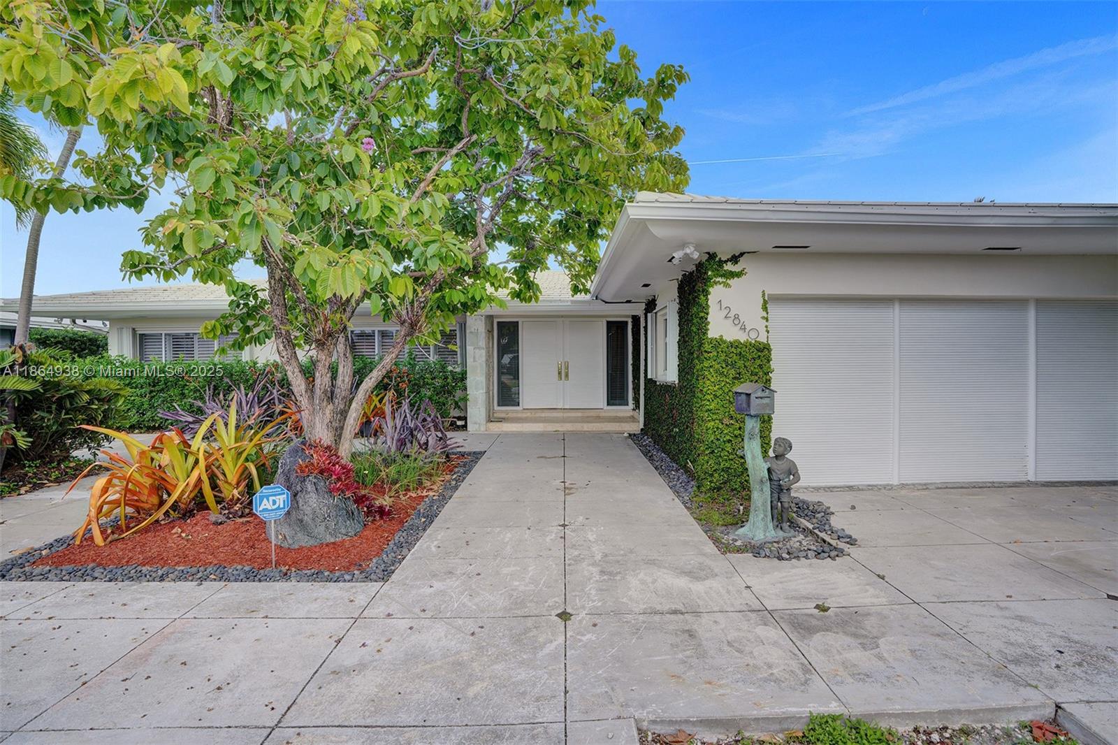 a view of a house with potted plants