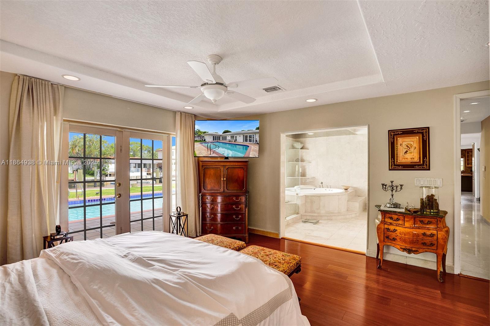 12840 Hickory Road North Miami, FL 33181 - Photo 15 of 21 a spacious bedroom with a bed and wooden floor