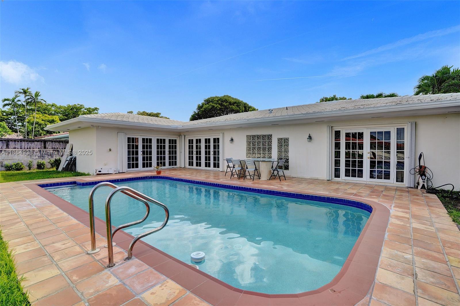 12840 Hickory Road North Miami, FL 33181 - Photo 2 of 21 a view of a house with swimming pool and sitting area