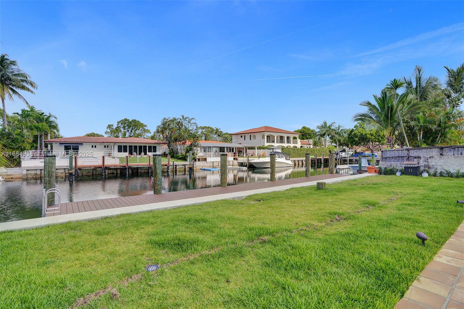 12840 Hickory Road North Miami, FL 33181 - Photo 3 of 21 a view of a chairs and table on the green field