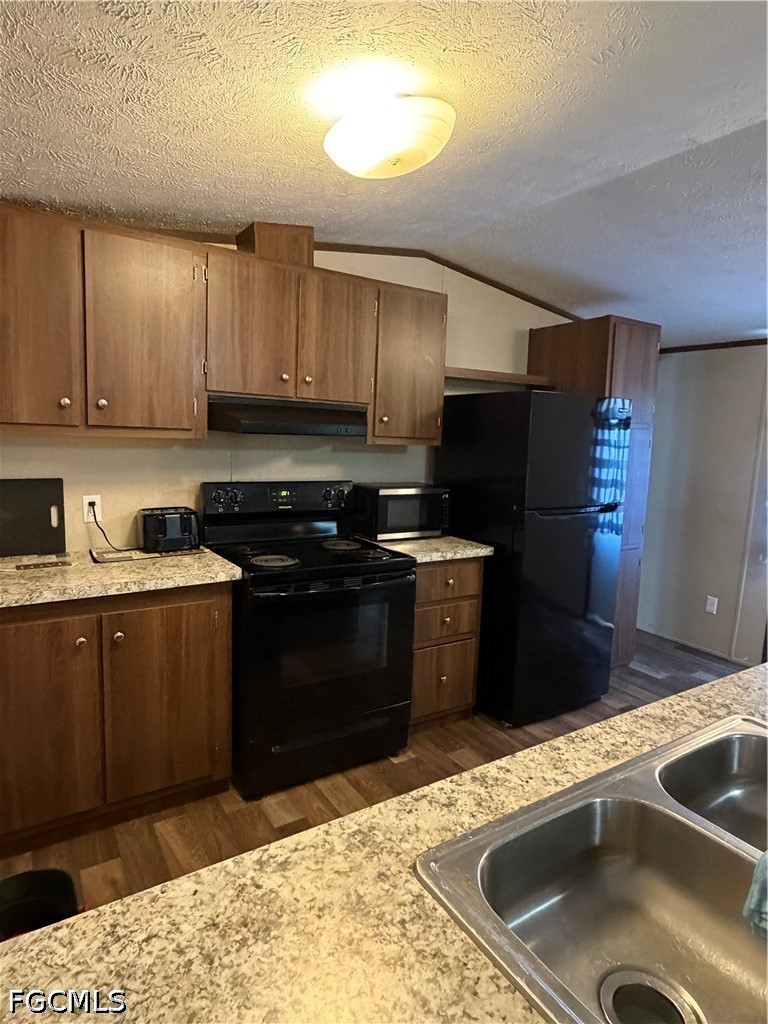 631 Stanton Street Clewiston, FL 33440 - Photo 5 of 24 a kitchen with a sink stove and refrigerator