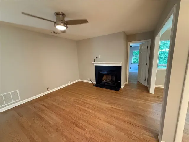 a view of empty room with a fireplace