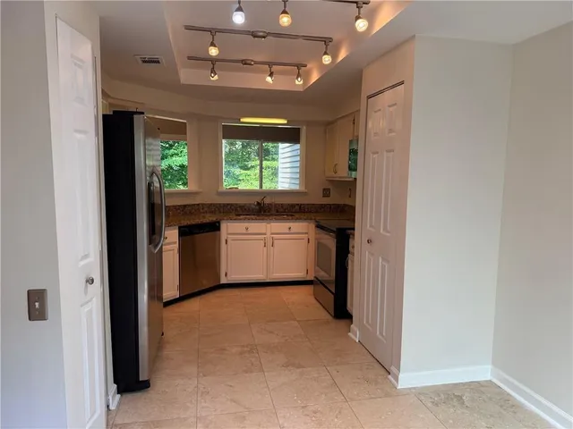 a kitchen with stainless steel appliances granite countertop a sink and cabinets