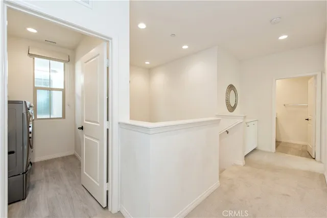 a view of a hallway with closet and wooden floor