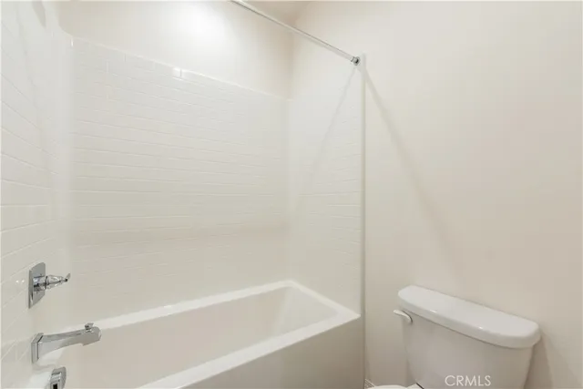 a bathroom with a bathtub and a toilet