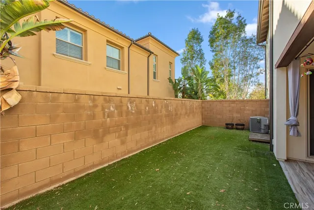 a view of yard with small space and wooden fence