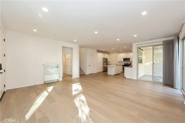 a view of a kitchen with a sink and a refrigerator