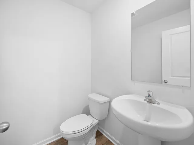 a white toilet sitting next to a white sink