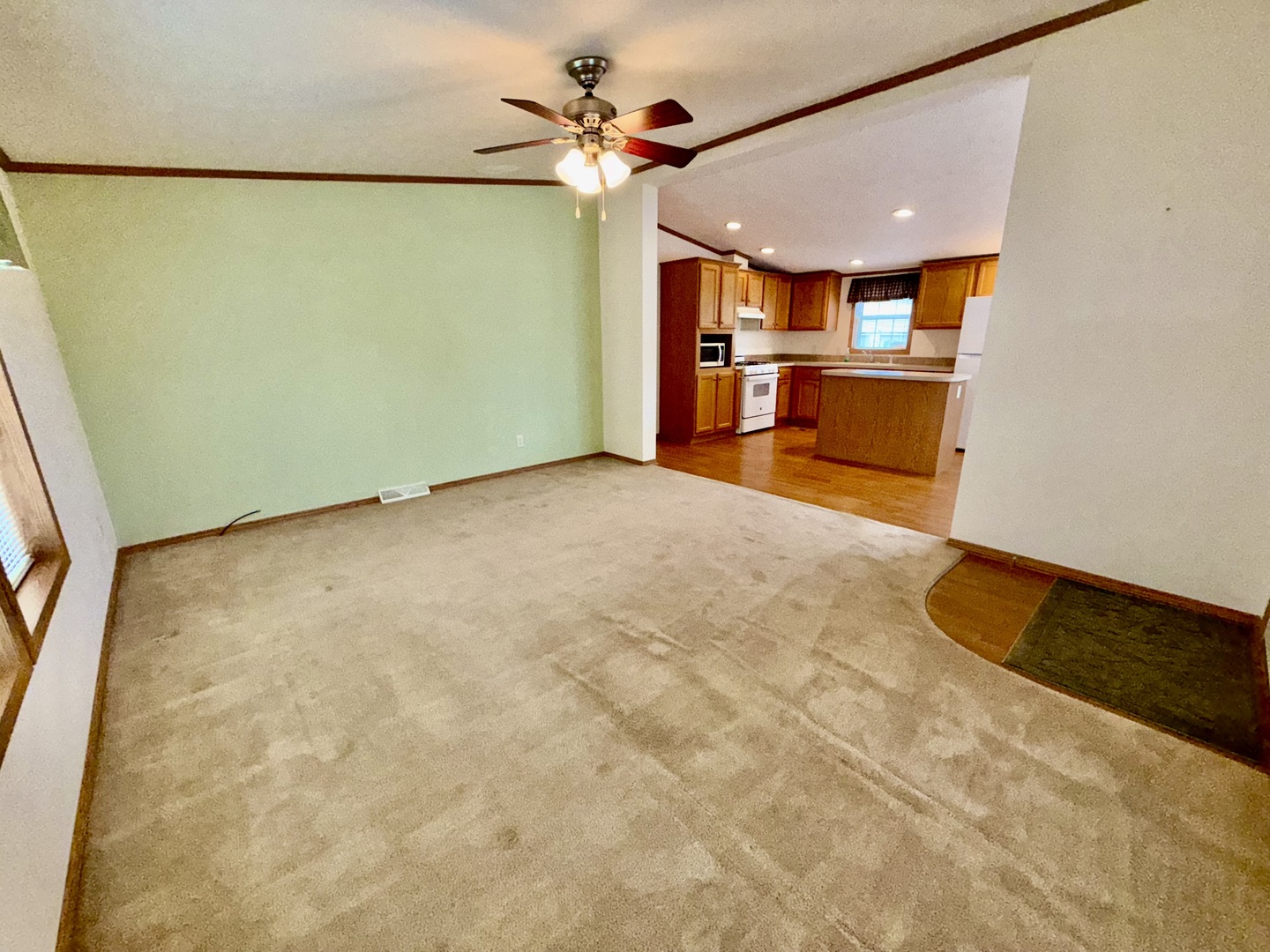 461 Meadowlark Circle, Unit A Sandwich, IL 60548 - Photo 13 of 28 a view of a kitchen with a refrigerator and a ceiling fan