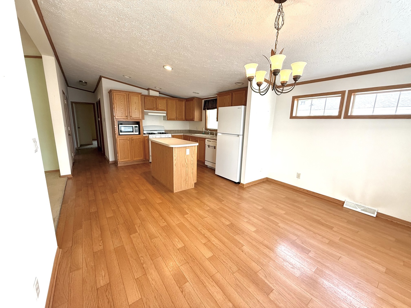 461 Meadowlark Circle, Unit A Sandwich, IL 60548 - Photo 2 of 28 a view of a kitchen with kitchen island stainless steel appliances wooden floor and dining table