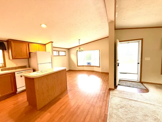 a view of a kitchen with wooden floor and a sink