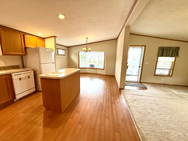a view of a kitchen with furniture and wooden floor