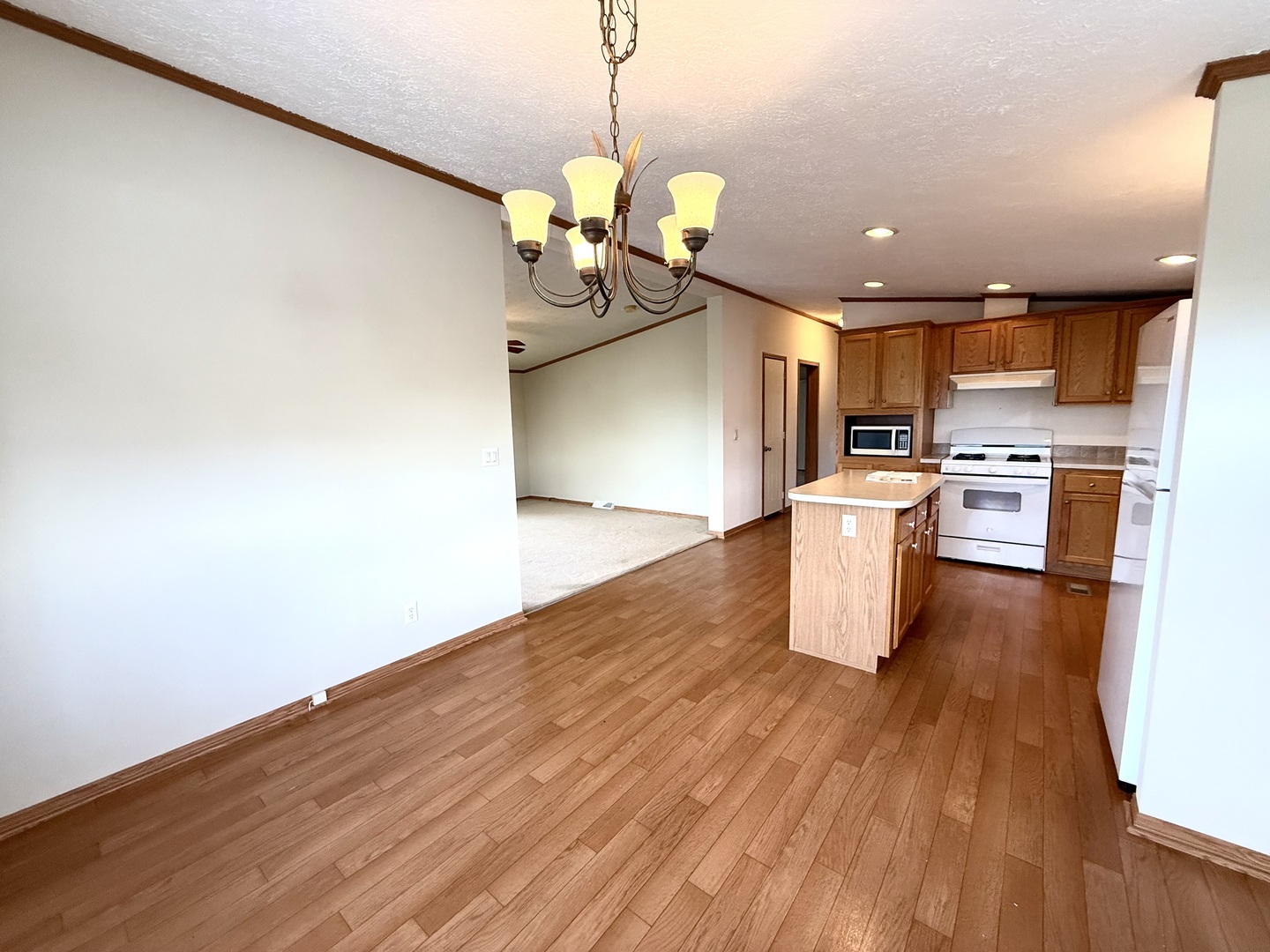 461 Meadowlark Circle, Unit A Sandwich, IL 60548 - Photo 3 of 28 a kitchen with stainless steel appliances granite countertop a wooden floors a stove and a wooden floors