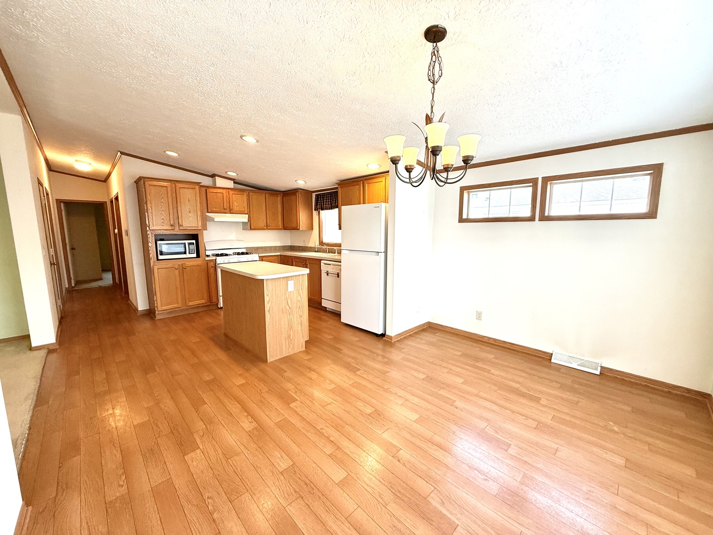 461 Meadowlark Circle, Unit A Sandwich, IL 60548 - Photo 7 of 28 a kitchen with stainless steel appliances granite countertop a refrigerator a sink dishwasher a stove and white cabinets with wooden floor
