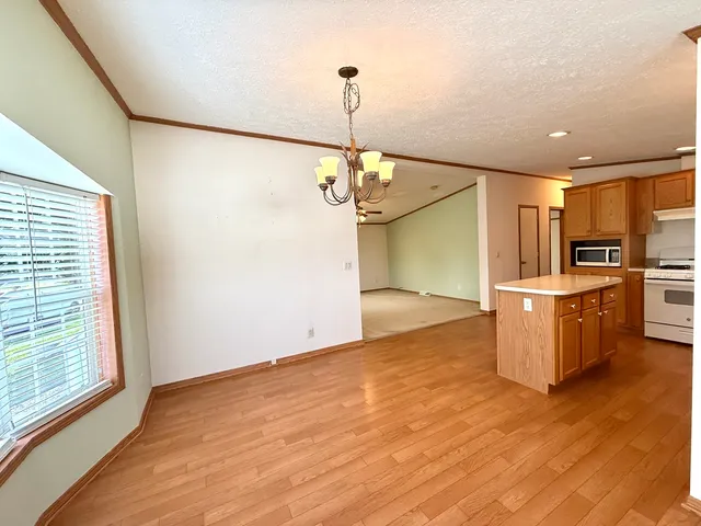 a view of a kitchen with a sink wooden floor and a kitchen