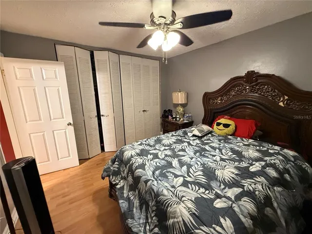 a bedroom with a bed and a mirror