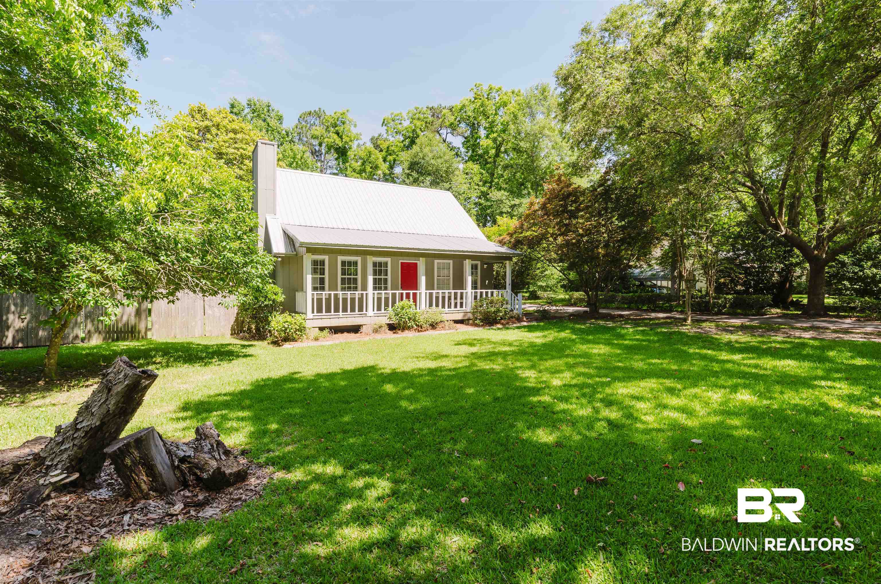 20460 Bishop Road Fairhope, AL 36532 - Photo 34 of 41 Back of property with a chimney, metal roof, and covered porch