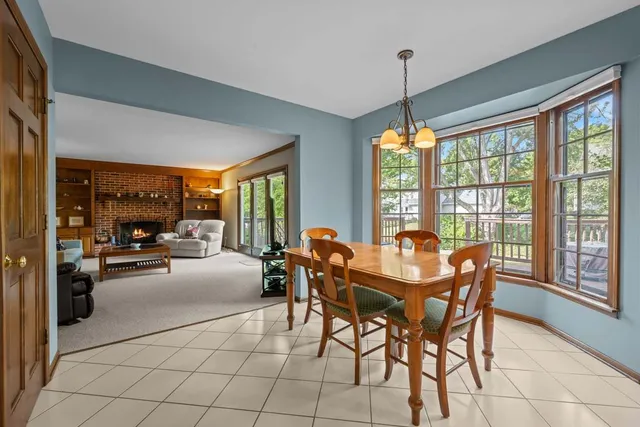 a dining room top with furniture and a floor to ceiling window