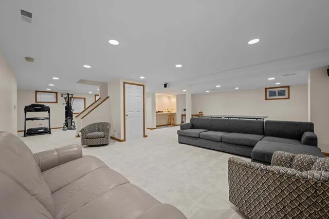 a living room with furniture and a stairs