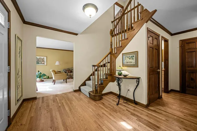 a view of entryway livingroom and hall with wooden floor