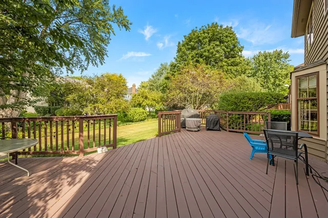 a balcony with wooden floor and fence